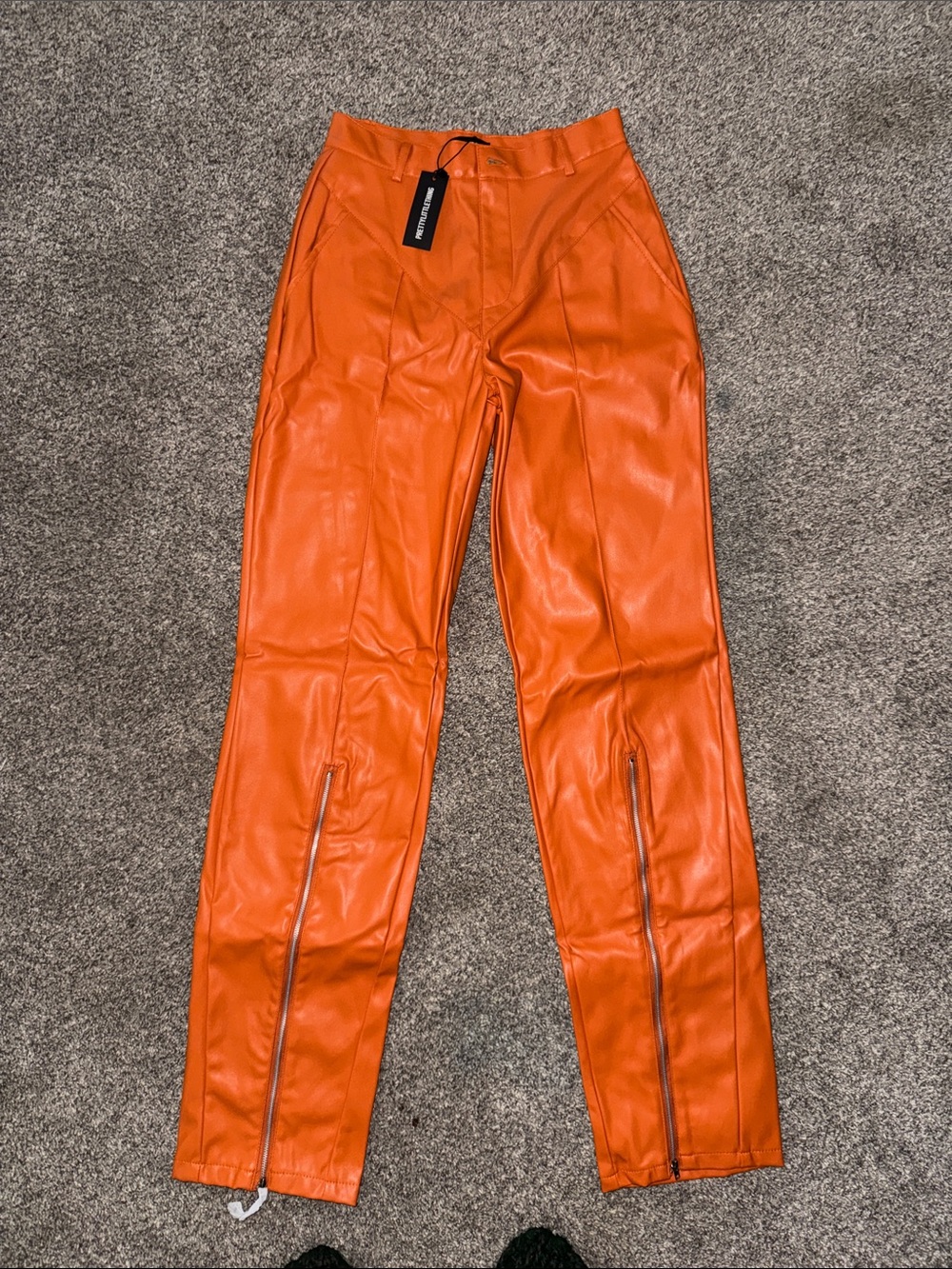 PrettyLittleThing Orange Faux Leather Zip Hem Pants
